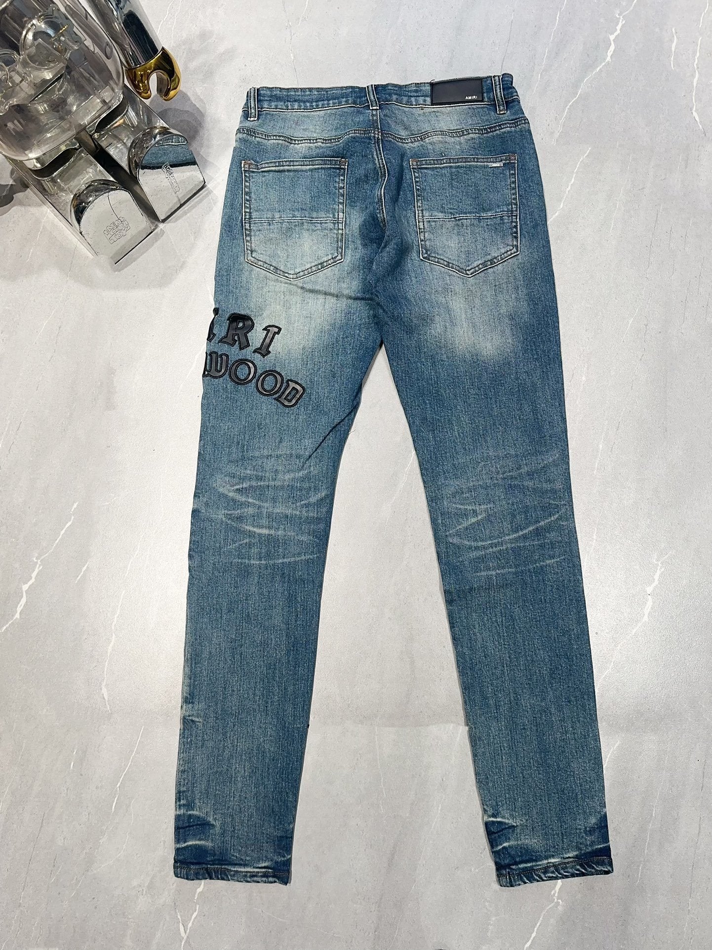 AMIRI DISTRESSED EMBROIDERED JEANS