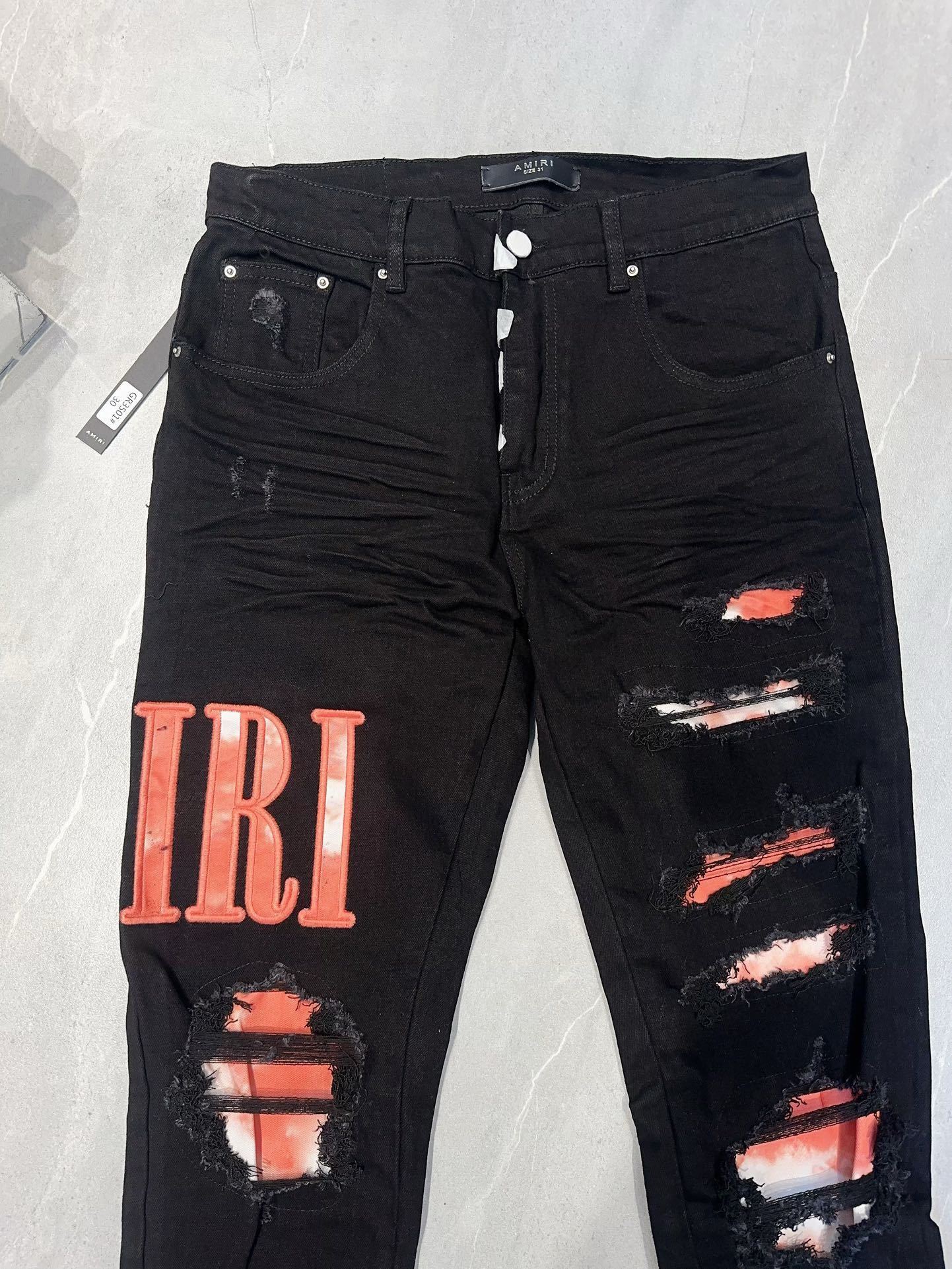 AMIRI WAXED LOGO-APPLIQUE SKINNY JEANS