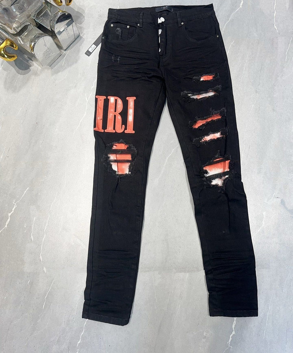 AMIRI WAXED LOGO-APPLIQUE SKINNY JEANS