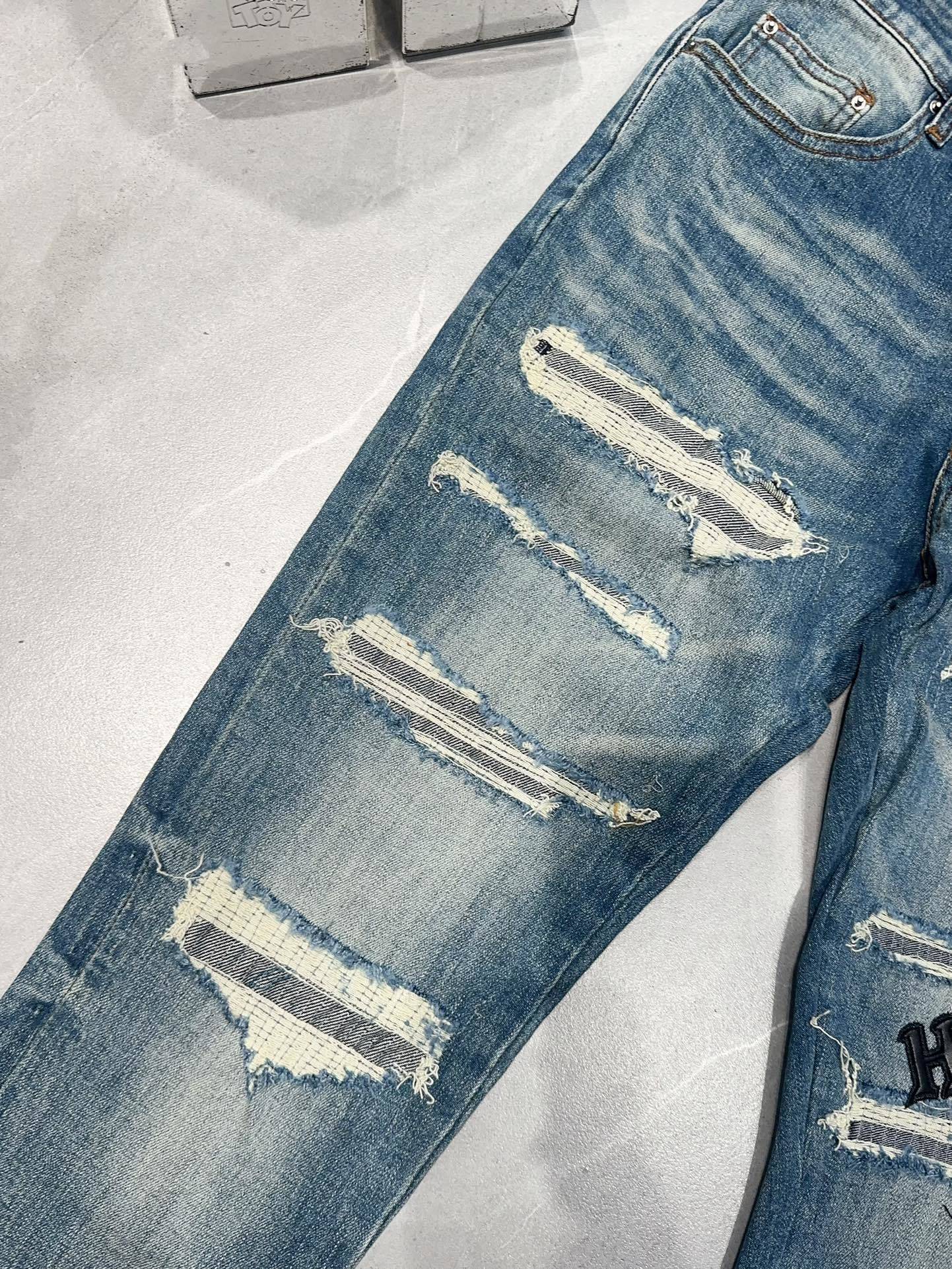 AMIRI DISTRESSED EMBROIDERED JEANS