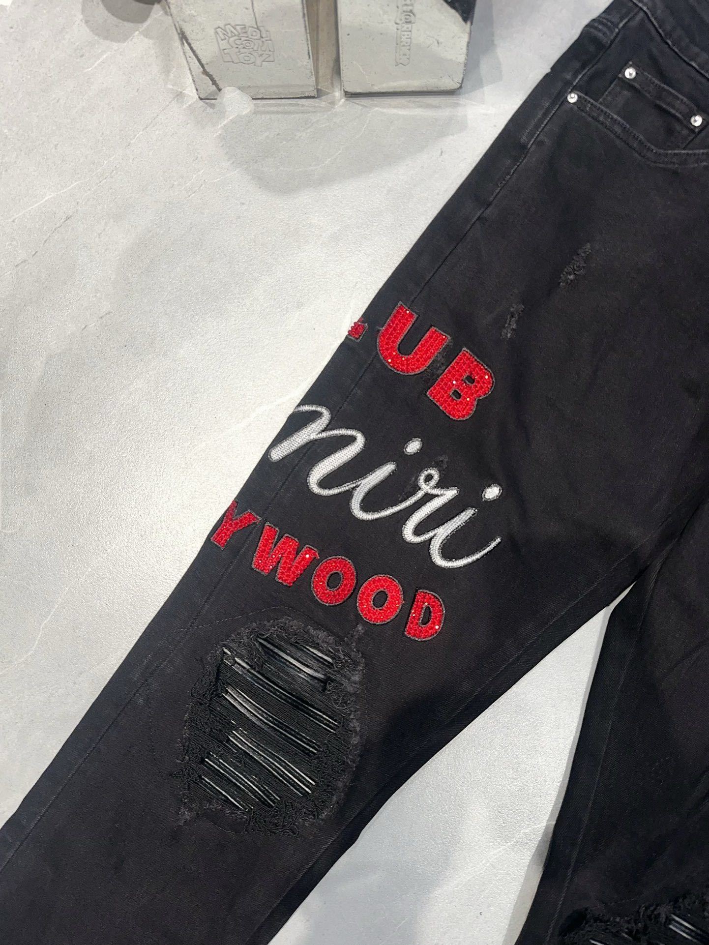 AMIRI EMBROIDERED DISTRESSED JEANS