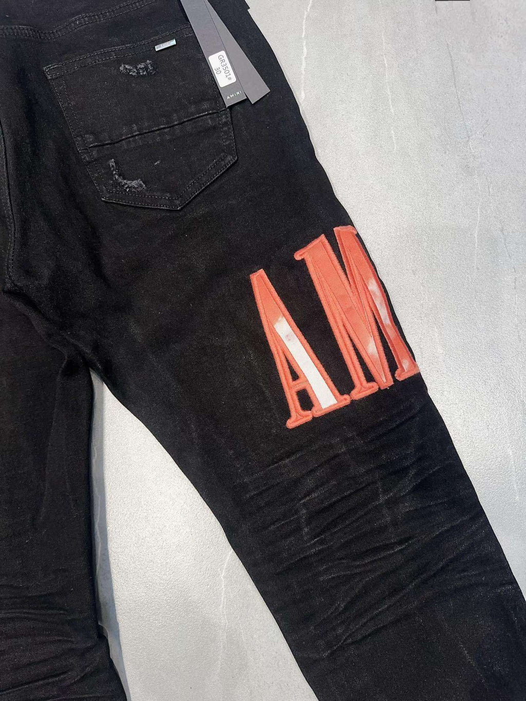 AMIRI WAXED LOGO-APPLIQUE SKINNY JEANS