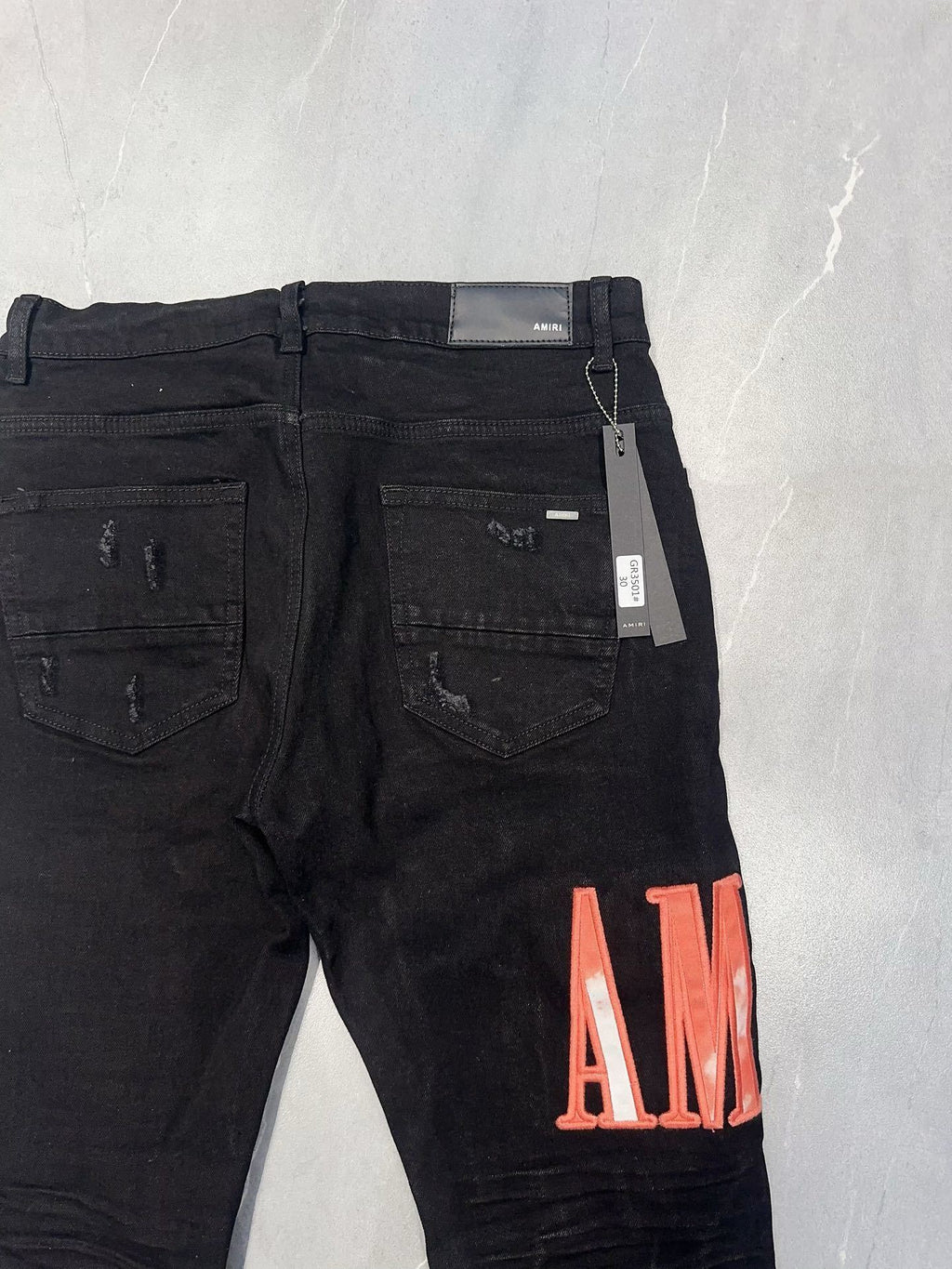 AMIRI WAXED LOGO-APPLIQUE SKINNY JEANS